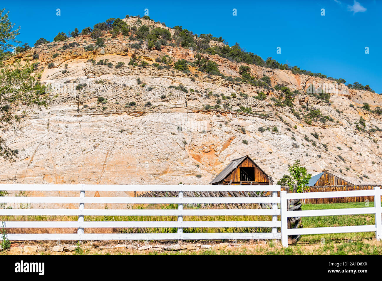 Old vintage wooden farm cabin and fence on road in Grand Staircase