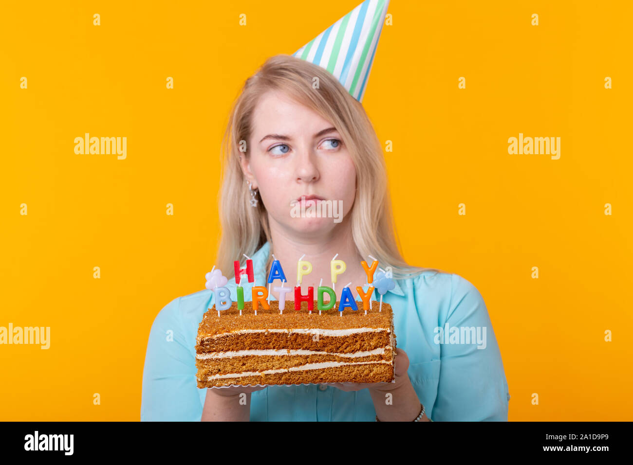Funny Positive Young Woman Holds In Her Hands A Homemade Cake With The Inscription Happy Birthday Posing On A Yellow Background Concept Of Holidays A Stock Photo Alamy