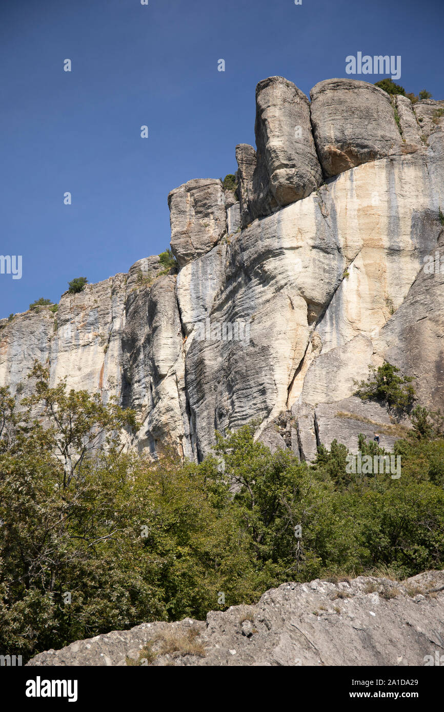 The vertical cliffs of the stone of Bismantova with  the blue sky in the background. Vertical shot. Stock Photo