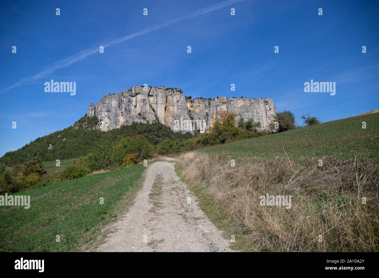 The stone of Bismantova, an isolated impressive spur in the italian appenines region. View from the rural path in the fields. Stock Photo