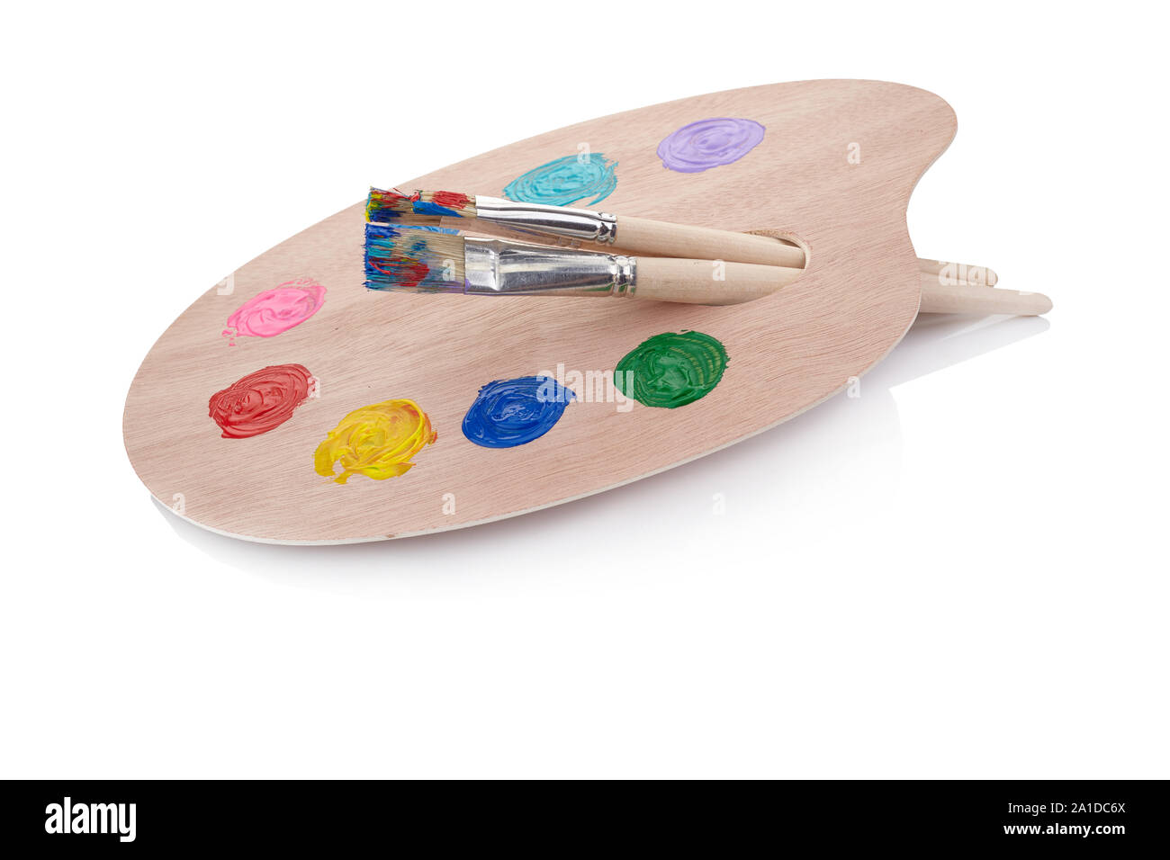 Wooden palette with paints and brushes isolated on white background Stock Photo