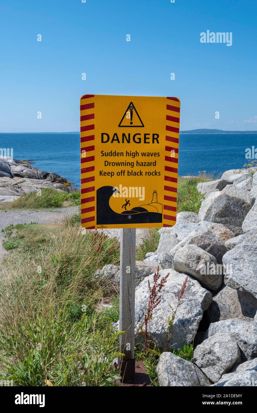 Warning sign for dangerous surf, Peggy's Cove, Nova Scotia, Canada