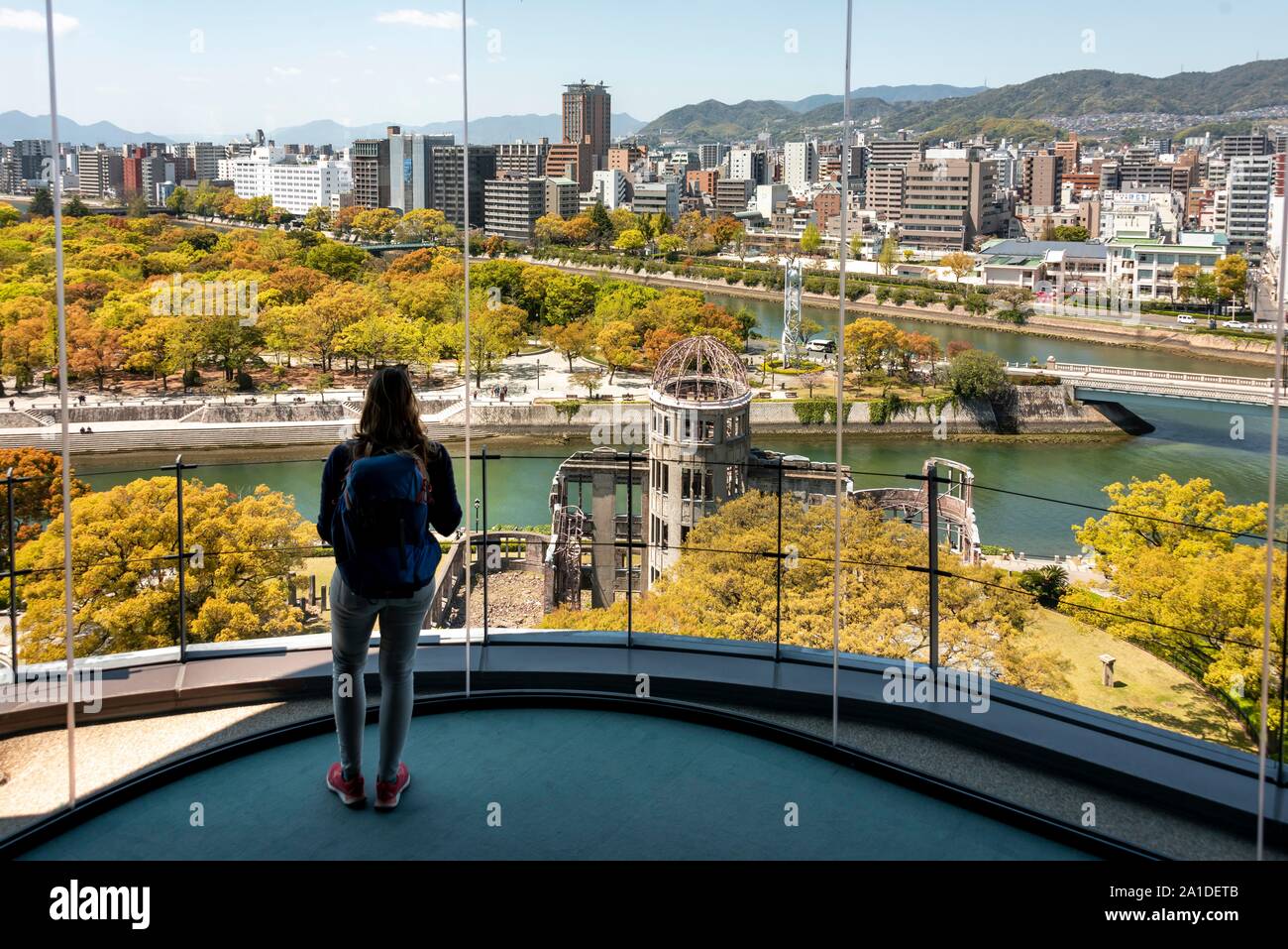 Woman looking from observation platform of Hiroshima Orizuru Tower, panoramic view over the city with atomic bomb dome, Atomic Bomb Dome, and Stock Photo