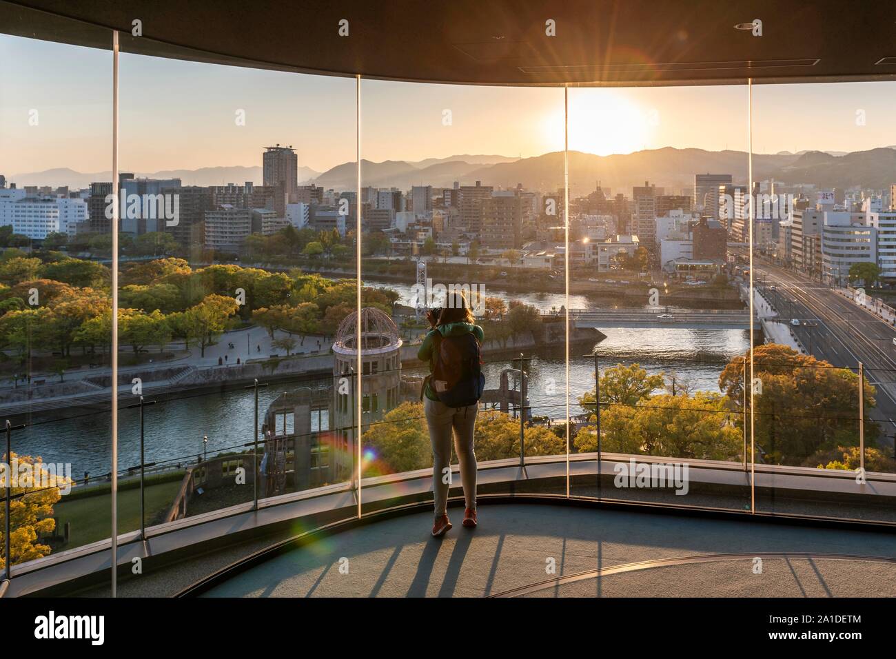 Woman looking from observation platform of Hiroshima Orizuru Tower, panoramic view over the city with atomic bomb dome, Atomic Bomb Dome, and Stock Photo