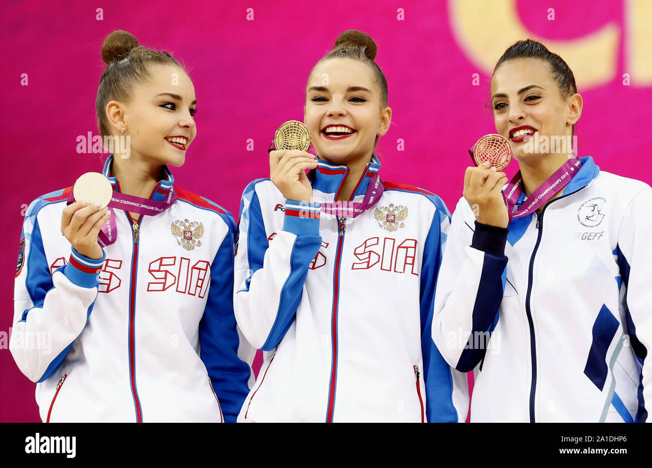 Russia's Dina Averina (C) poses after winning the individual all-round ...