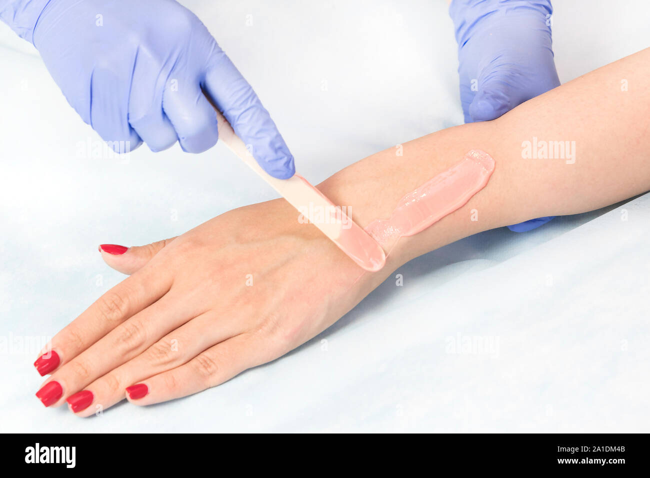 Closeup depilation process of female body parts in a beauty salon Stock