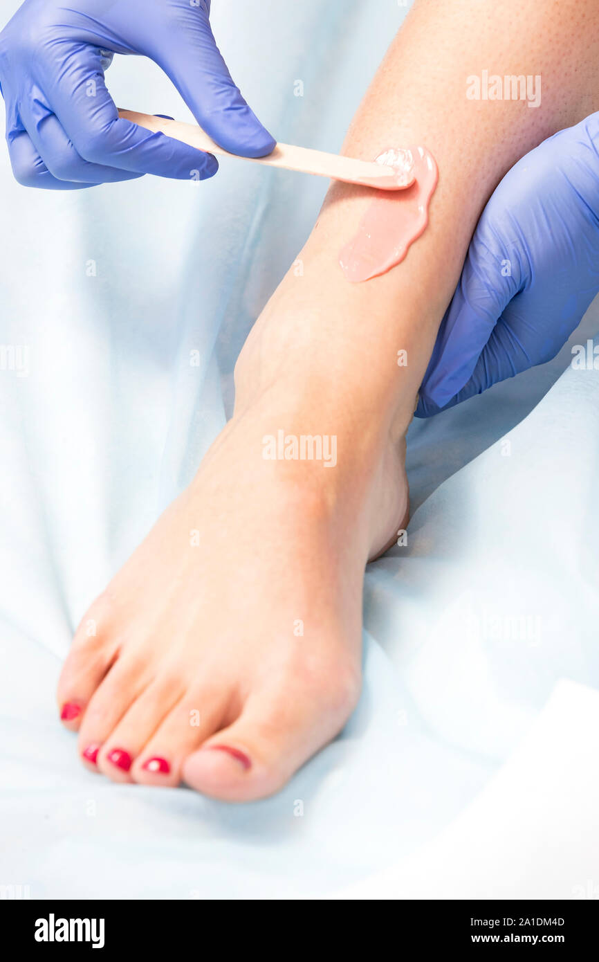 Closeup depilation process of female body parts in a beauty salon Stock