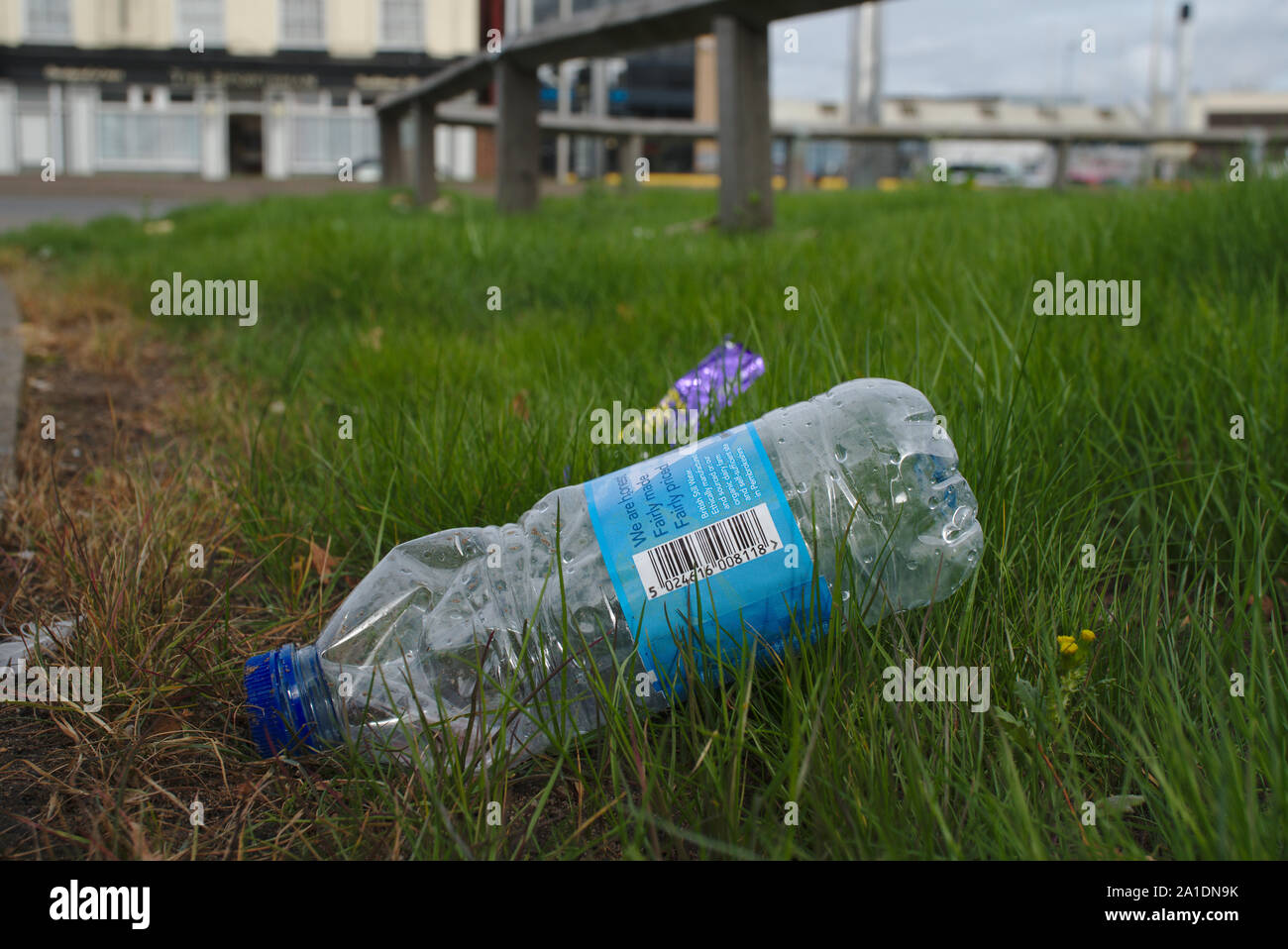 Discarded plastic bottle near roadside. Birmingham. British Isles. Stock Photo