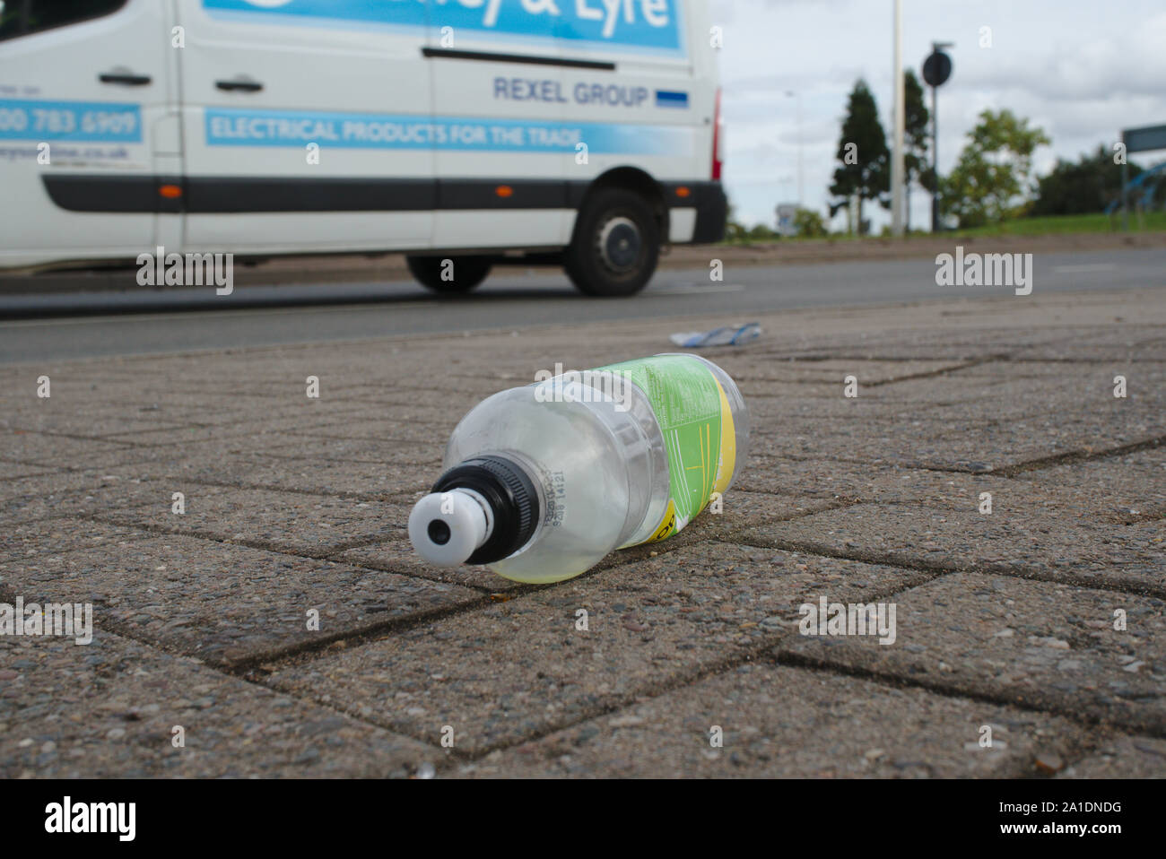 Discarded plastic bottle on pavement. Birmingham. British Isles Stock Photo