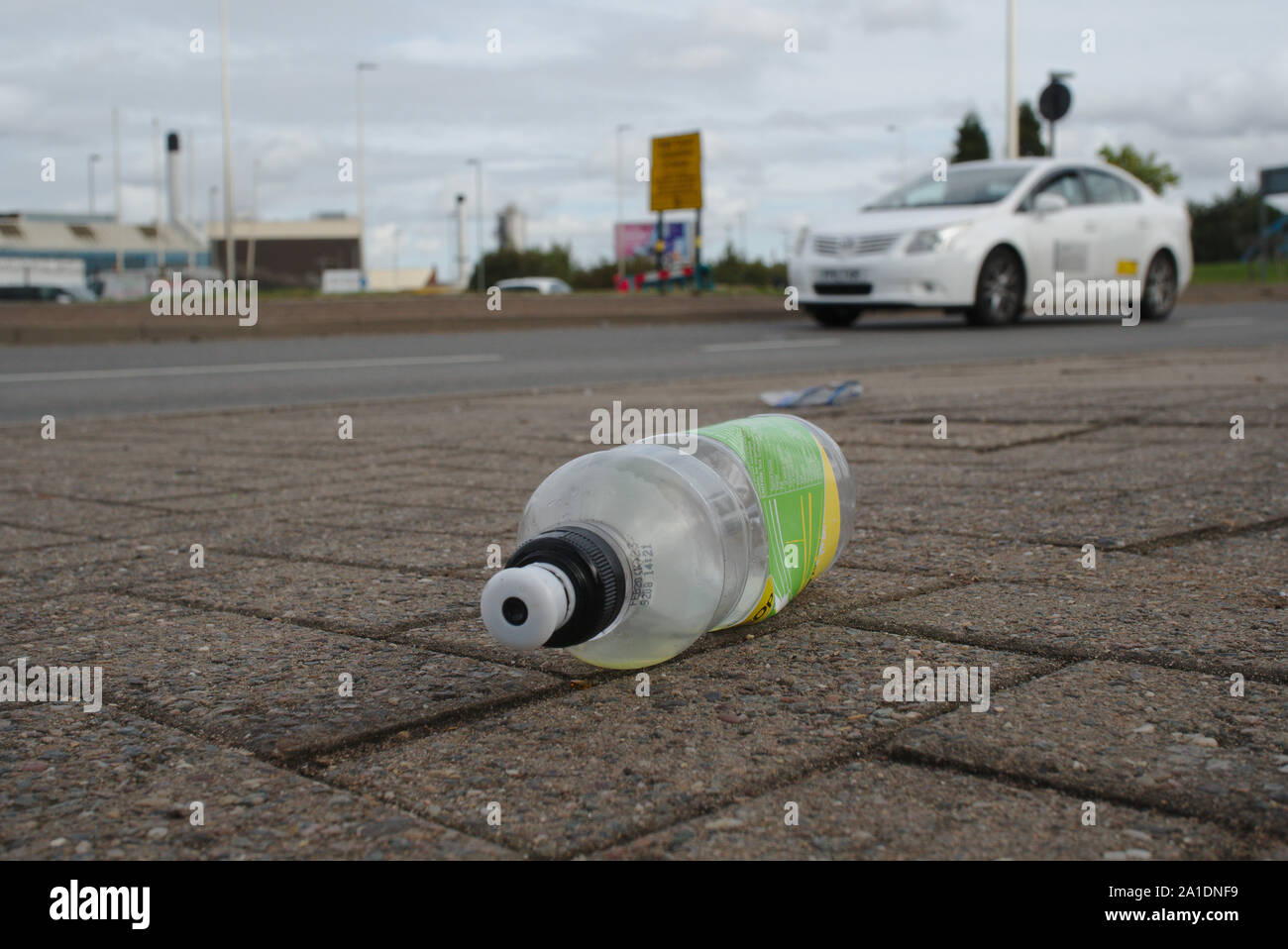 Discarded plastic bottle on pavement. Birmingham. British Isles Stock Photo