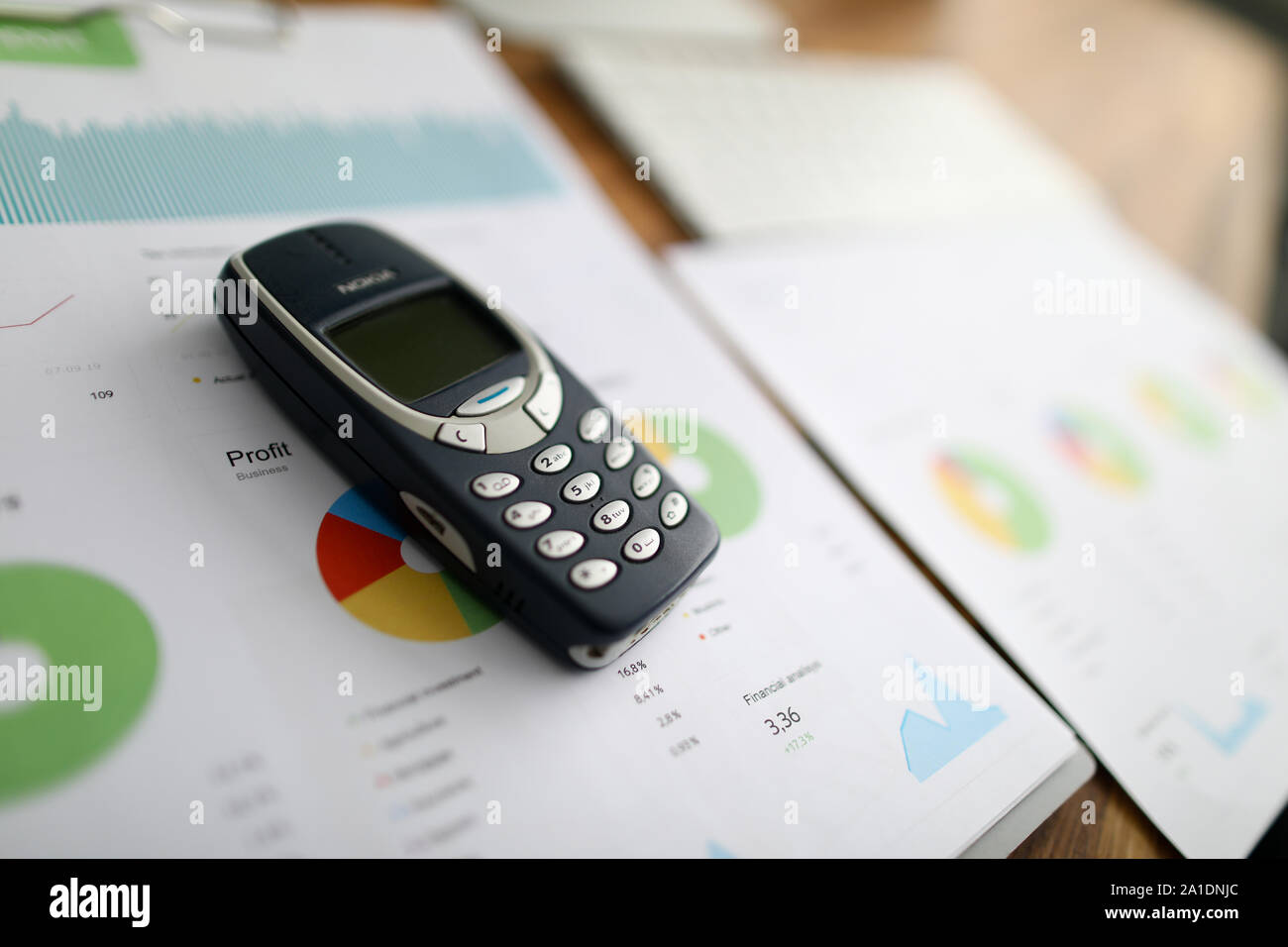 Nokia 3310 ol phone with business chart Stock Photo