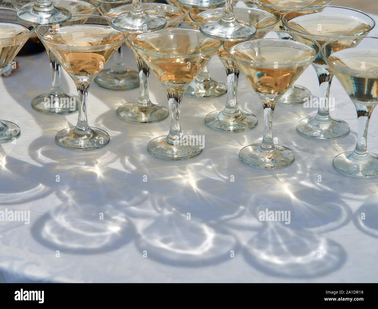 Beautiful champagne glasses are mounted one on top of the other. The