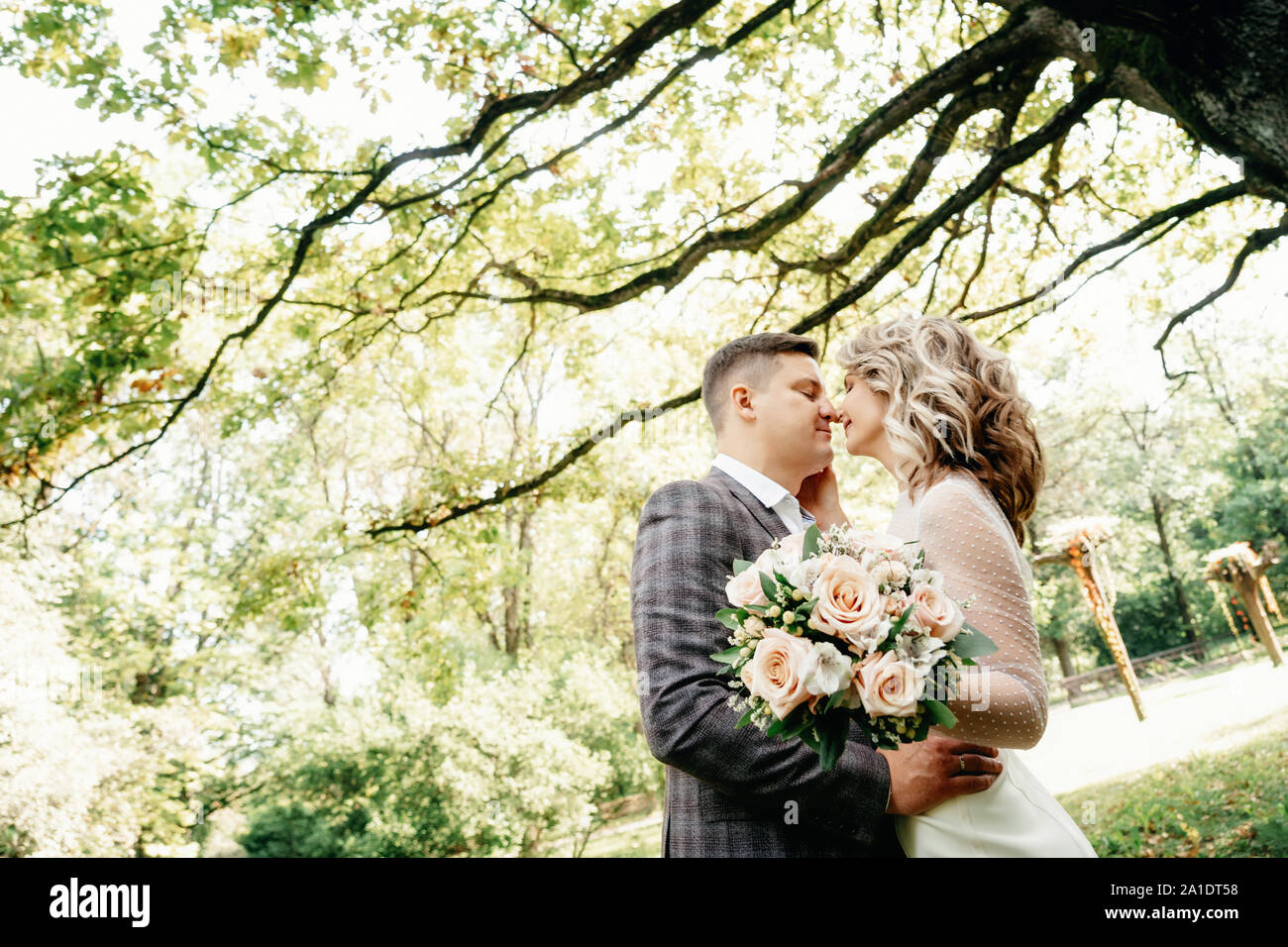 Couple kissing against tree hi-res stock photography and images - Alamy