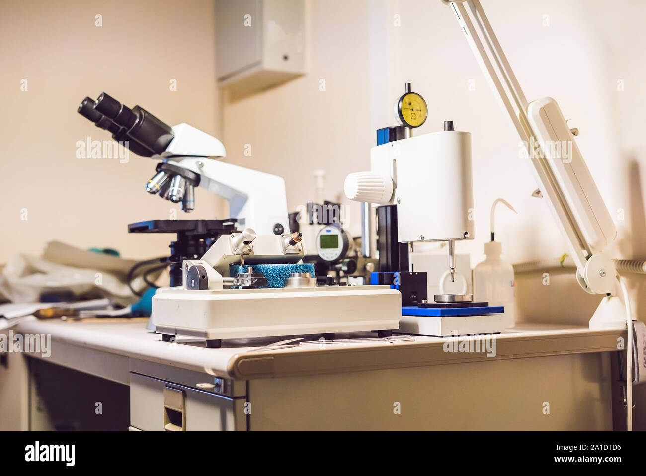 A sample preparation table in aelecron microscopy laboratory with an optical microscope