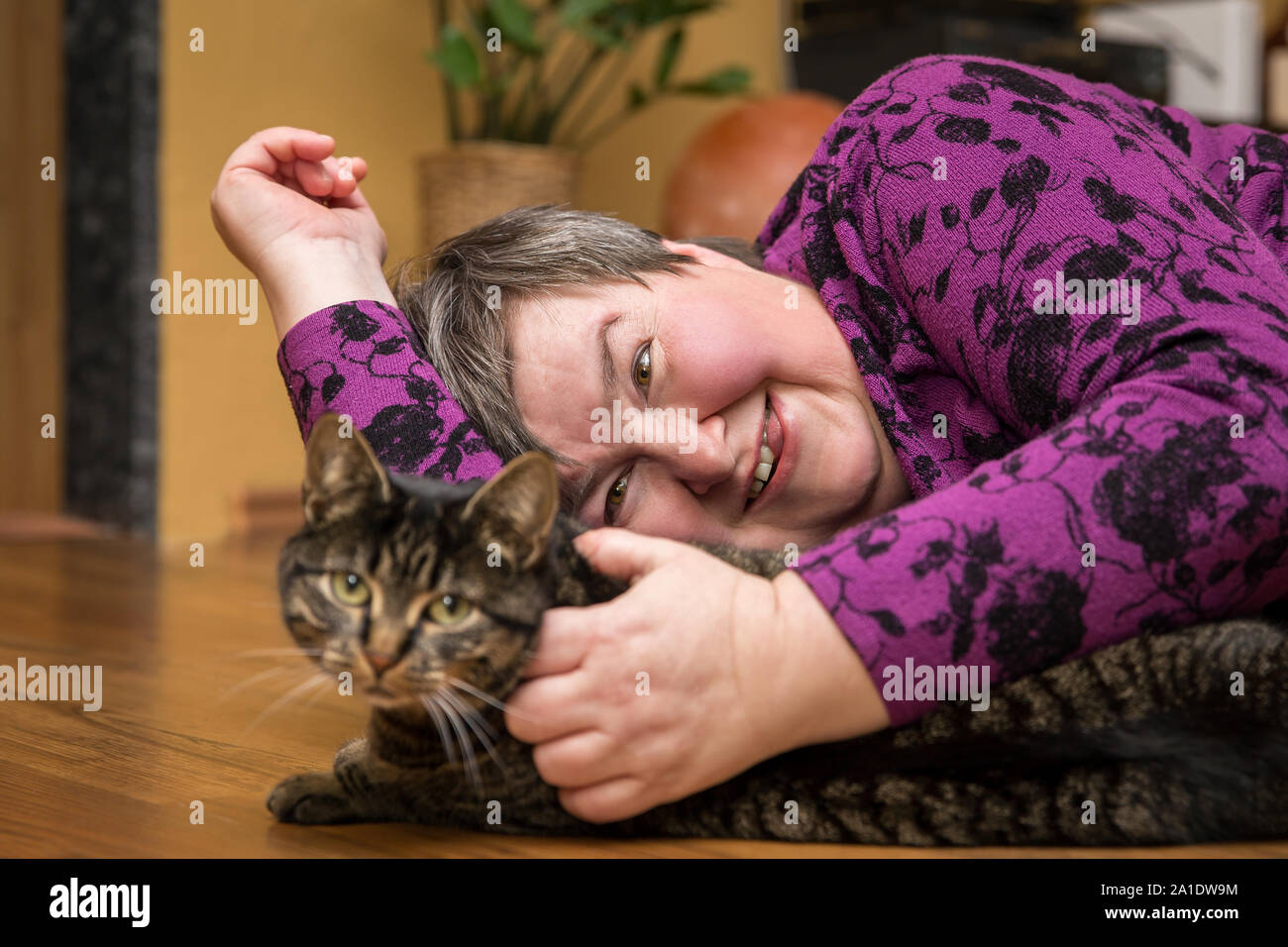 mentally disables woman cuddling a cat, animal assisted therapy Stock Photo