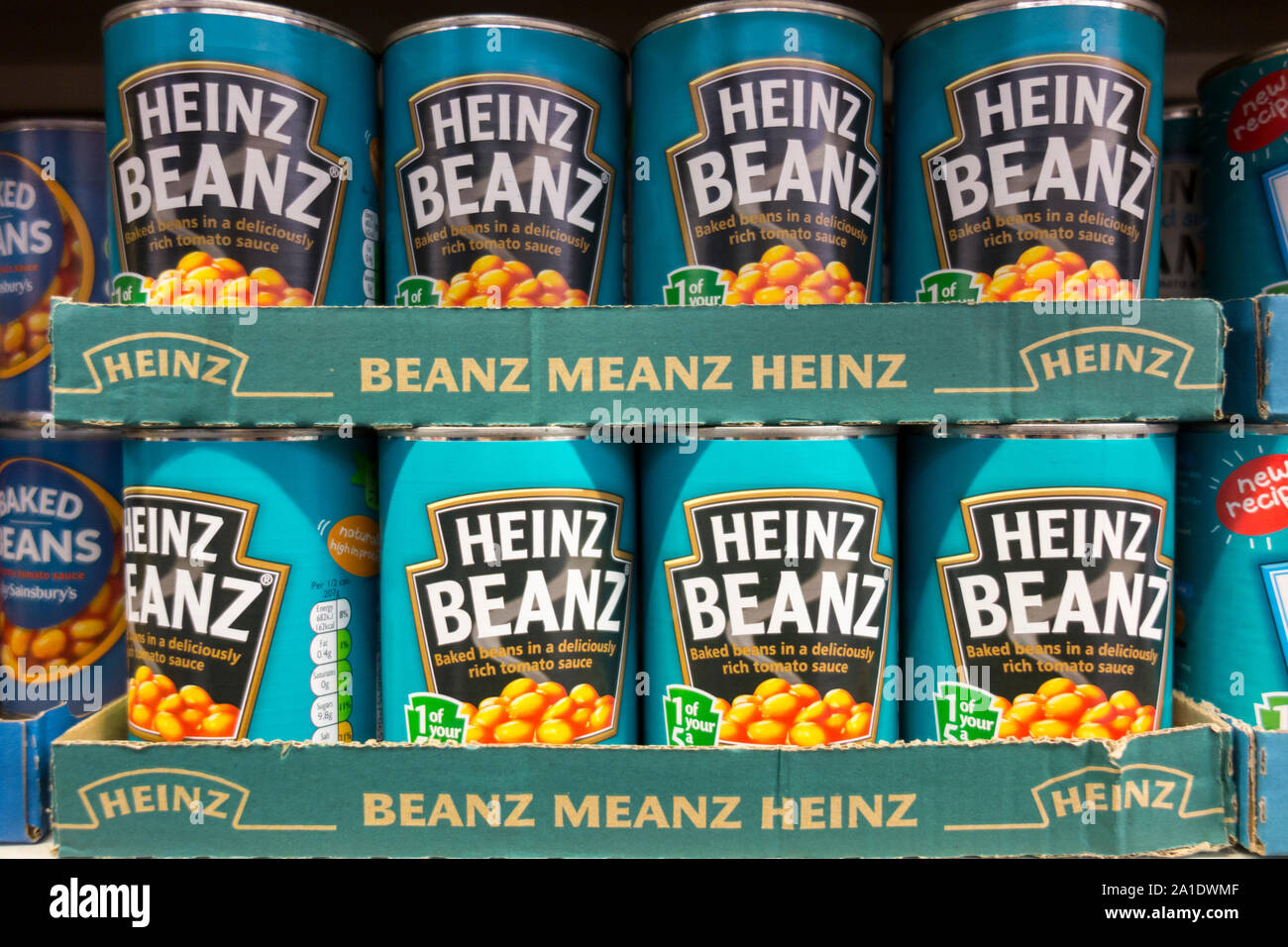 Tins of Heinz Baked Beans on a supermarket shelf in London, England, UK