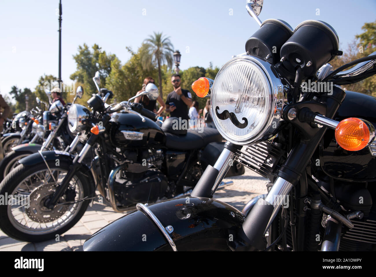 Seville, Andalusia, Spain - Motorcycles lined up at the Plaza de España for the Distinguished Gentleman's Ride. Stock Photo