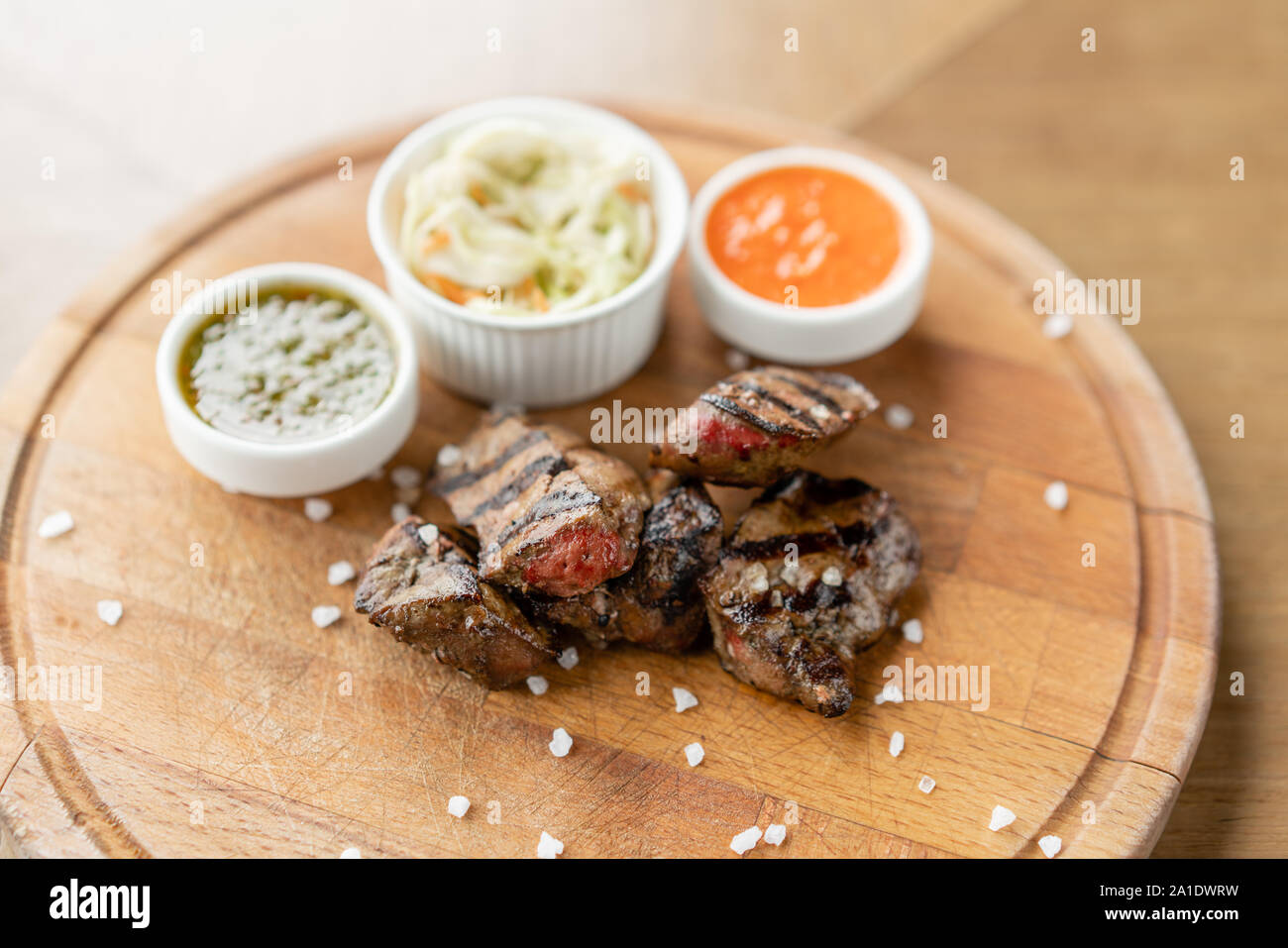 Pieces of liver cooked on the grill. Serving on a wooden Board