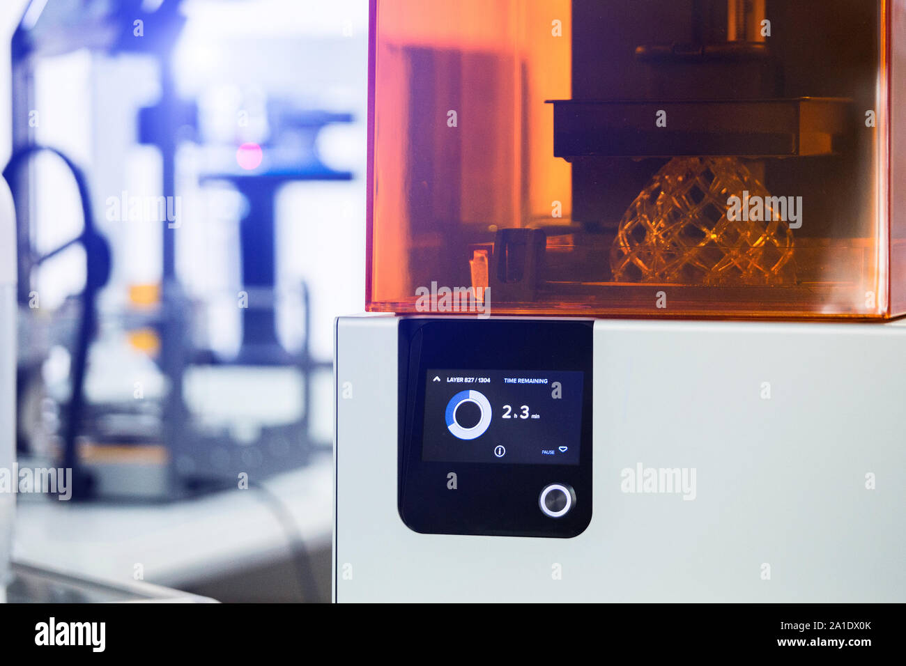 A stereolithography 3d printer in the laboratory prints a structure from a photopolymer. Stock Photo
