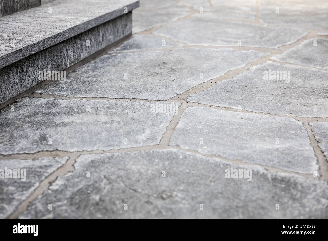 fresh builded stairs and grey flagstone floor with mortar joints Stock Photo
