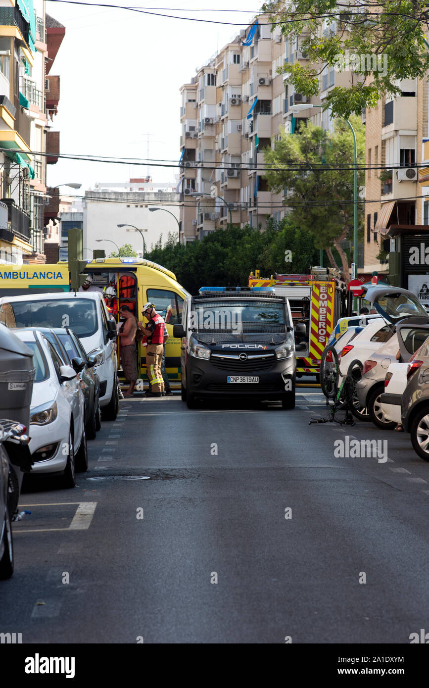 Spanish emergency services respond to an apartment fire.  Picture are National Police, Firefighters and Ambulance workers. Stock Photo