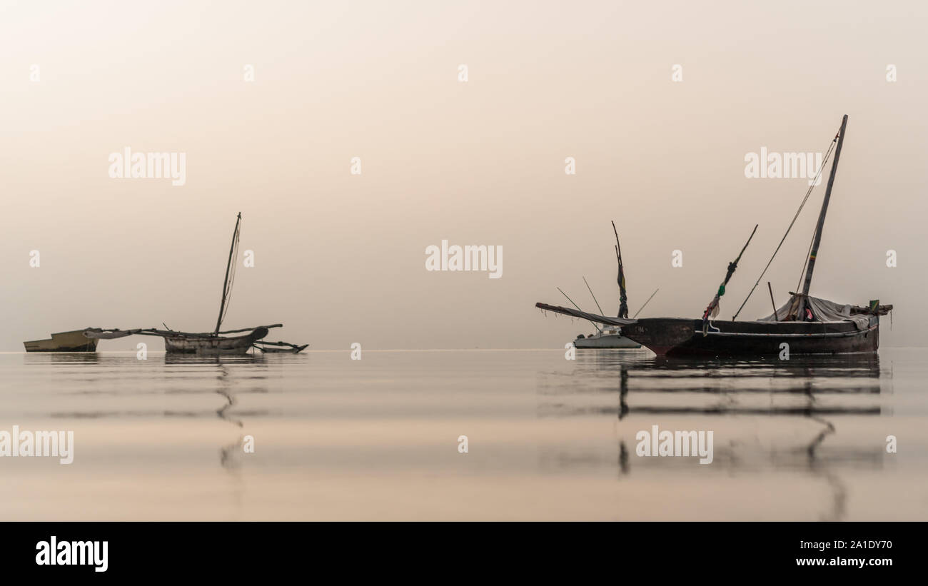 Boats laying on the still water of Indian Ocean just before the sunrise ...
