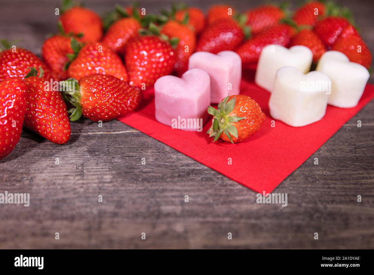 Frozen yogurt in a heart shape, Strawberries and froyo bites on wooden table Stock Photo