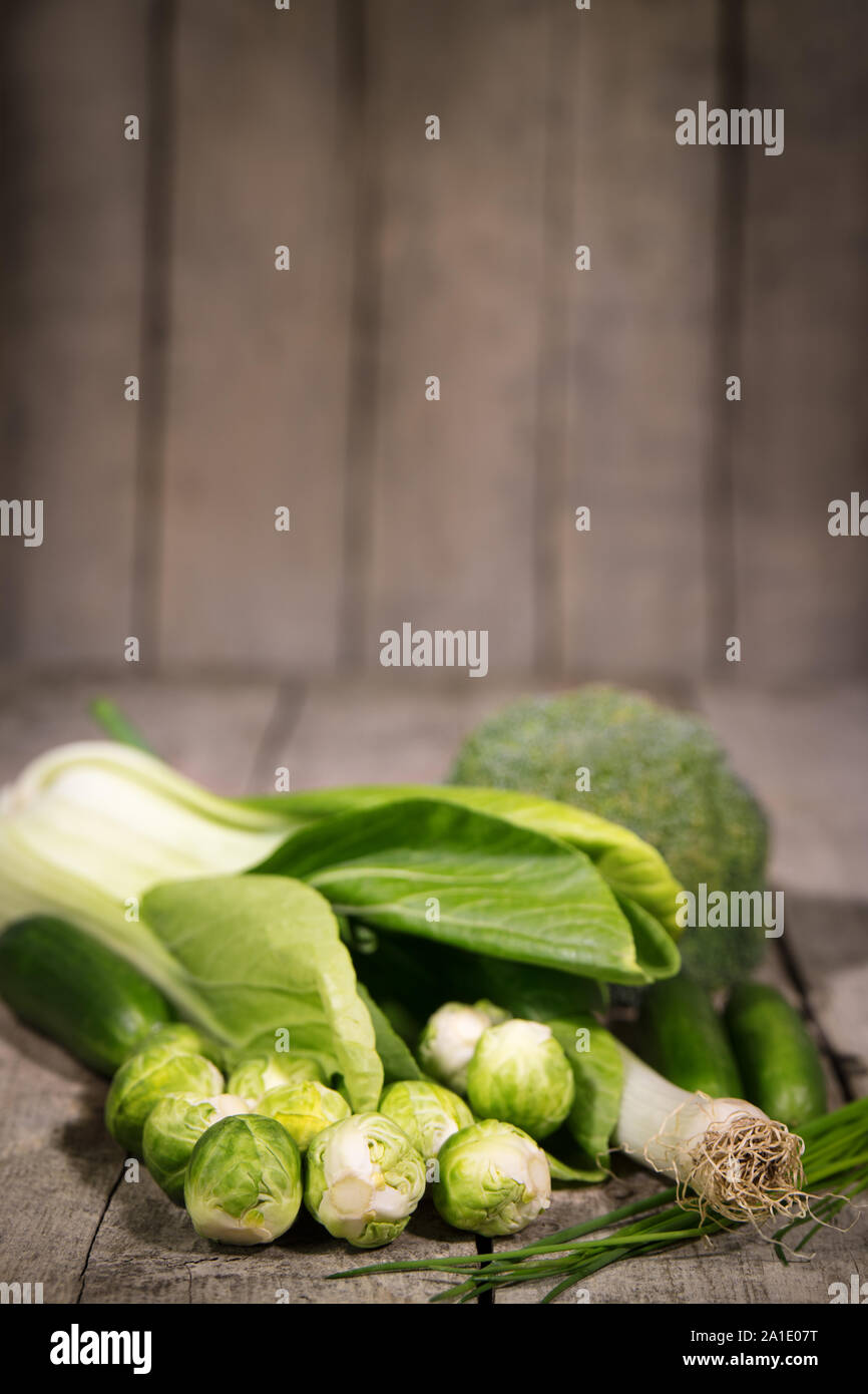 various green vegetables on a rustic wooden background Stock Photo