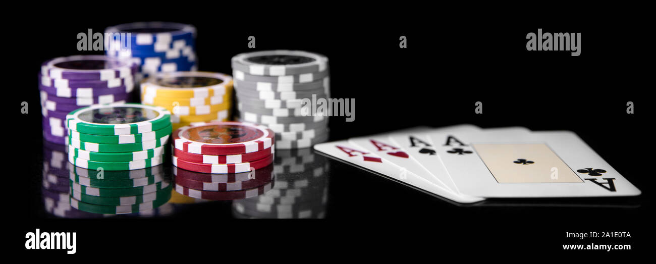 Gambling and casino, Playing cards and Poker Chips in front of black Background Stock Photo