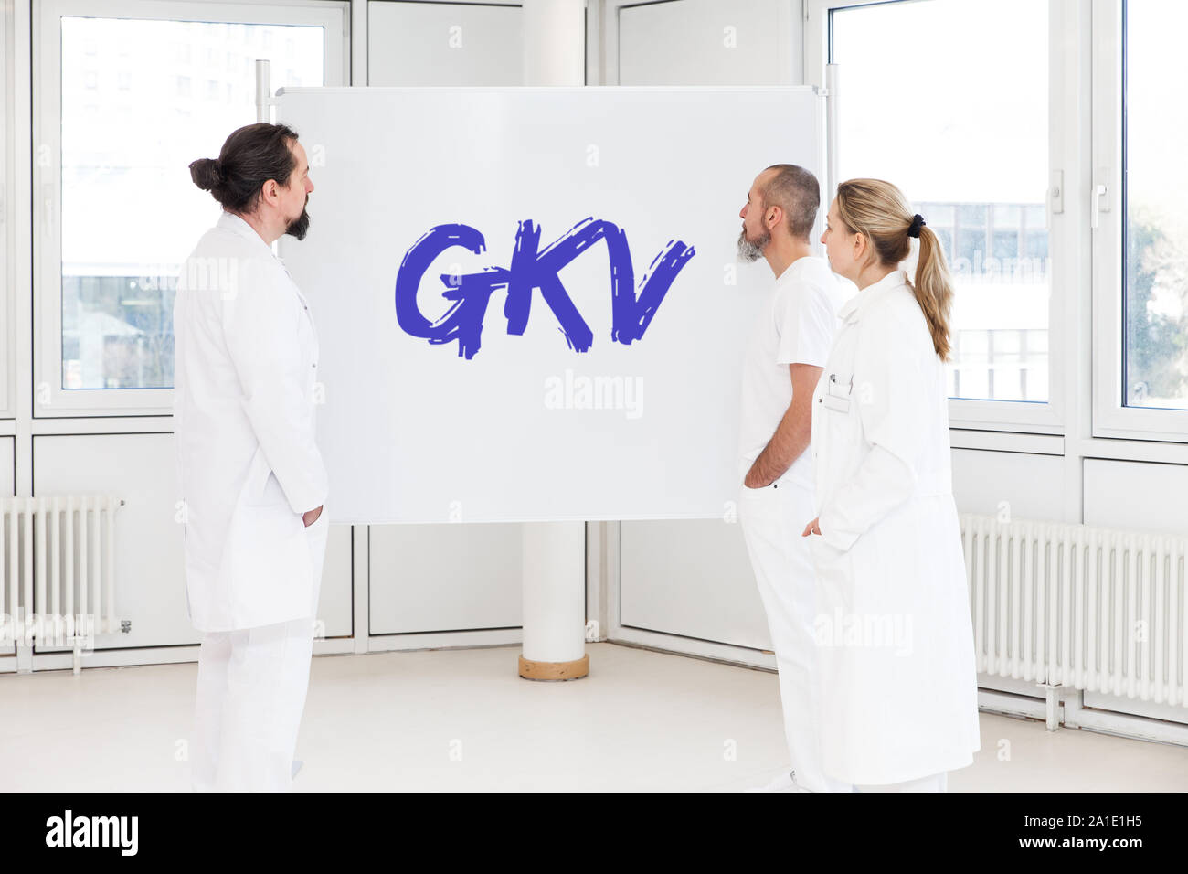 medicine staff in front of a white board with the letters gkv, which means gesetzliche krankenversicherung in german. this means national health insur Stock Photo