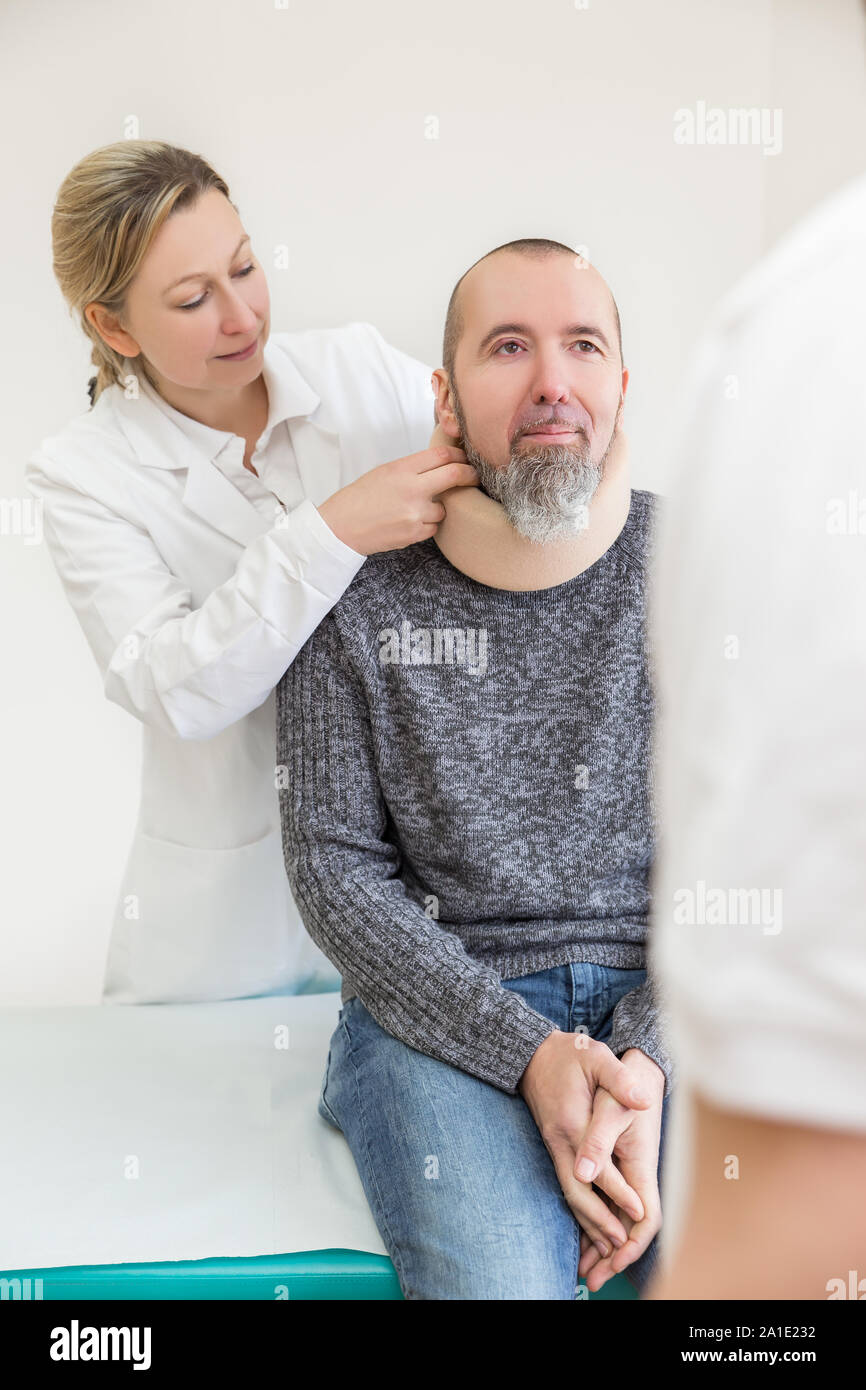male patient is getting a soft collar in a doctors office Stock Photo