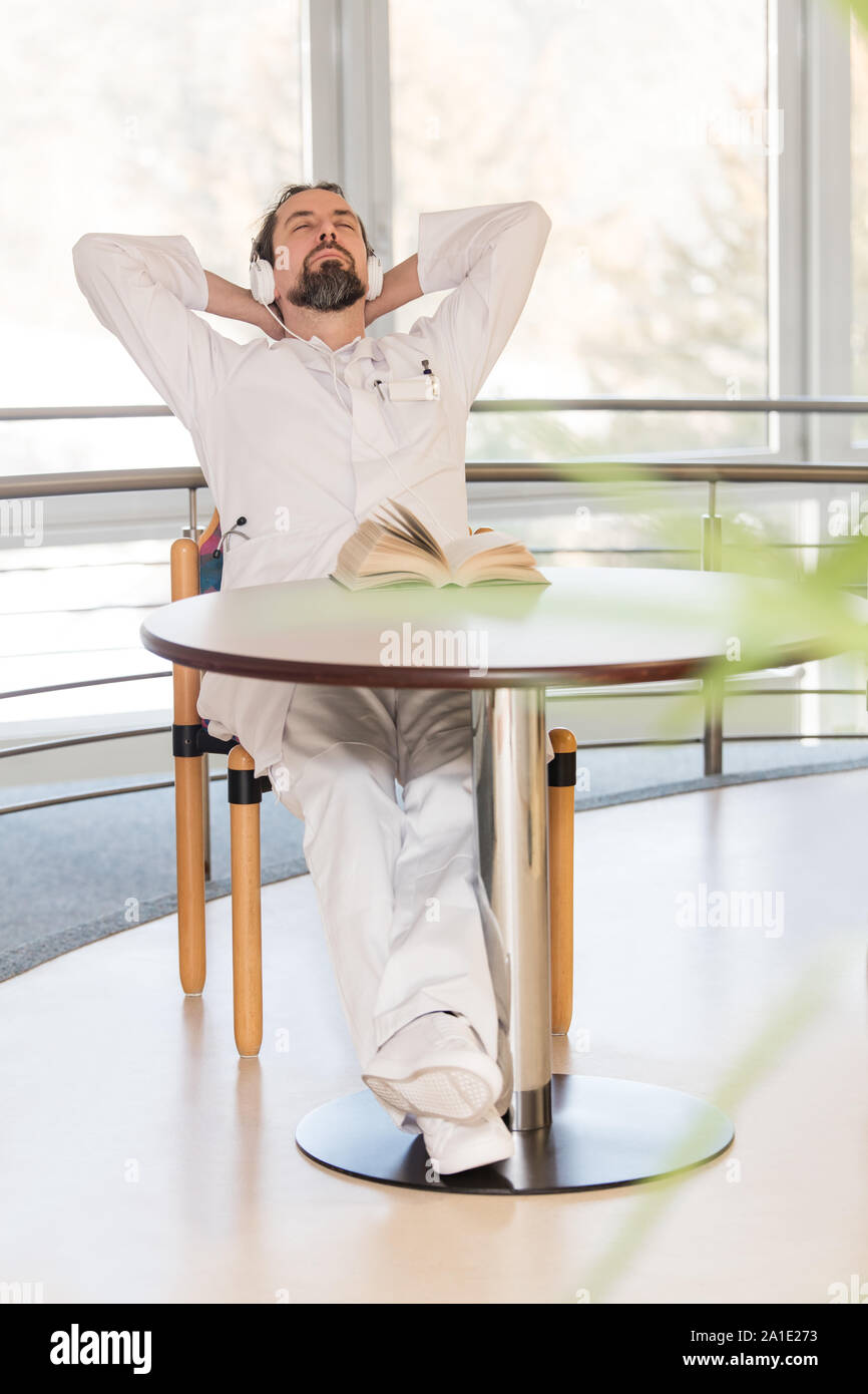 male doctor is having a break and is trying to sleep a bit Stock Photo