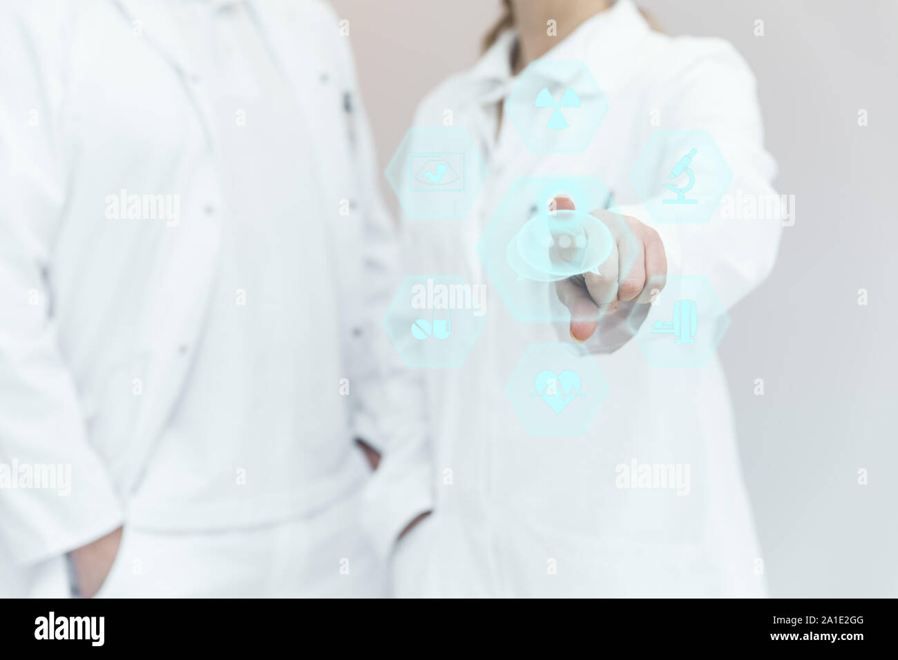 two medical professionals with an virtual touchscreen and medical icons, different therapy possibilities Stock Photo