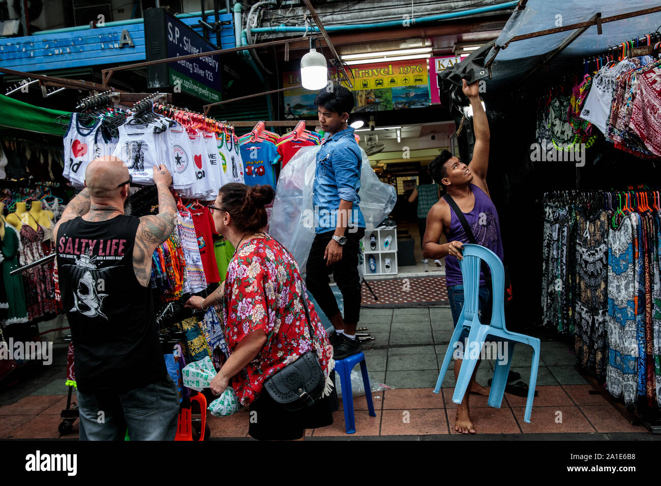 BANGKOK, THAILAND: Street vendors prepare to cover their stalls as rain  clouds move in on Khao San Road in Bangkok, Thailand on August 22nd, 2019.  Bangkoks bustling Khao San Road - a