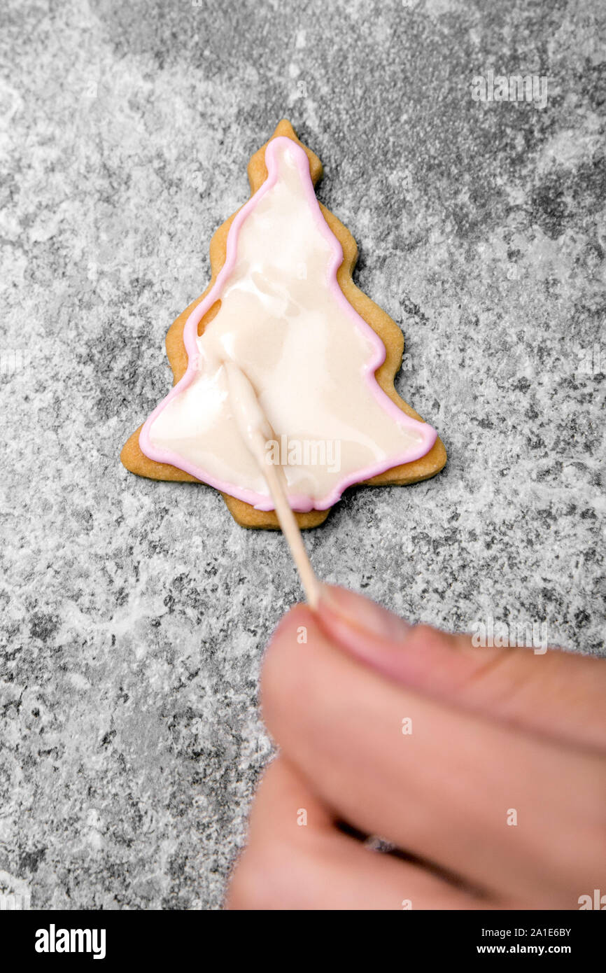 Christmas bakery, details of decoration a christmas tree cookie with royal icing or frosting Stock Photo