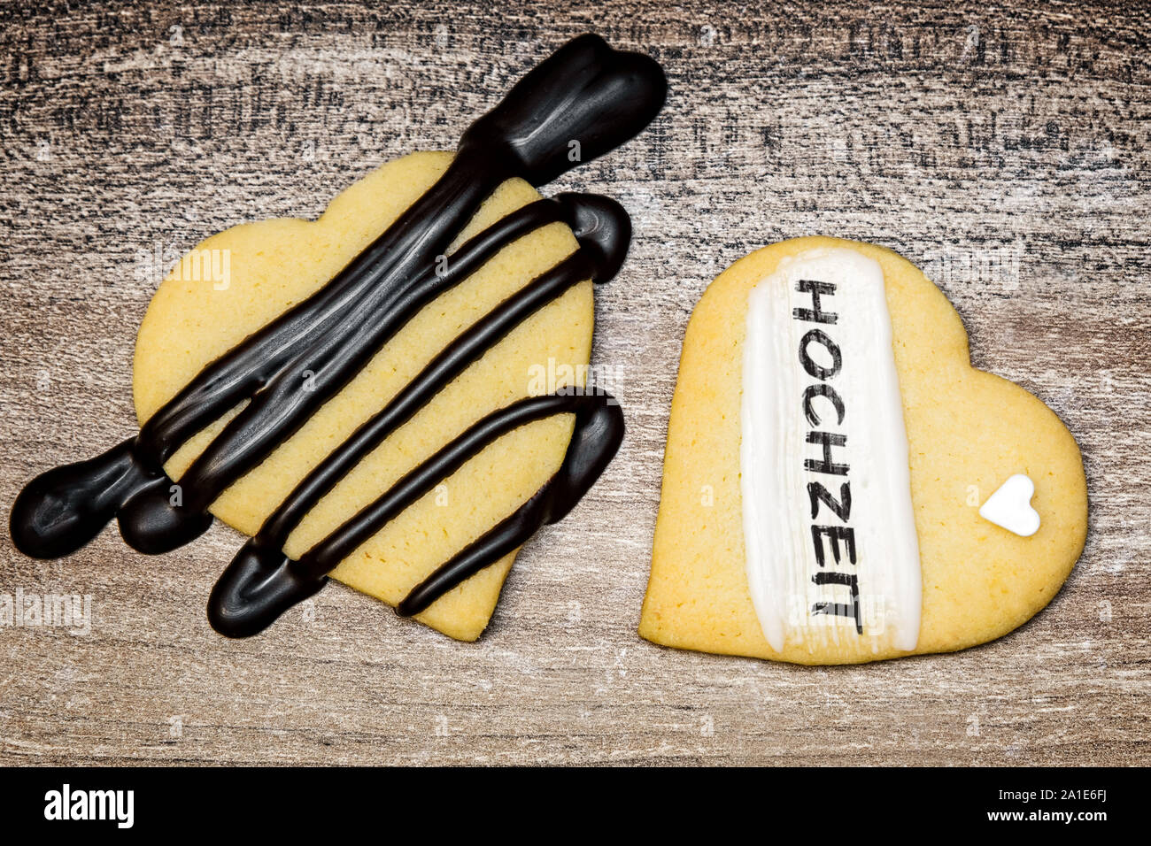 Two heart shape cookies with german word hochzeit, which means wedding or marriage Stock Photo