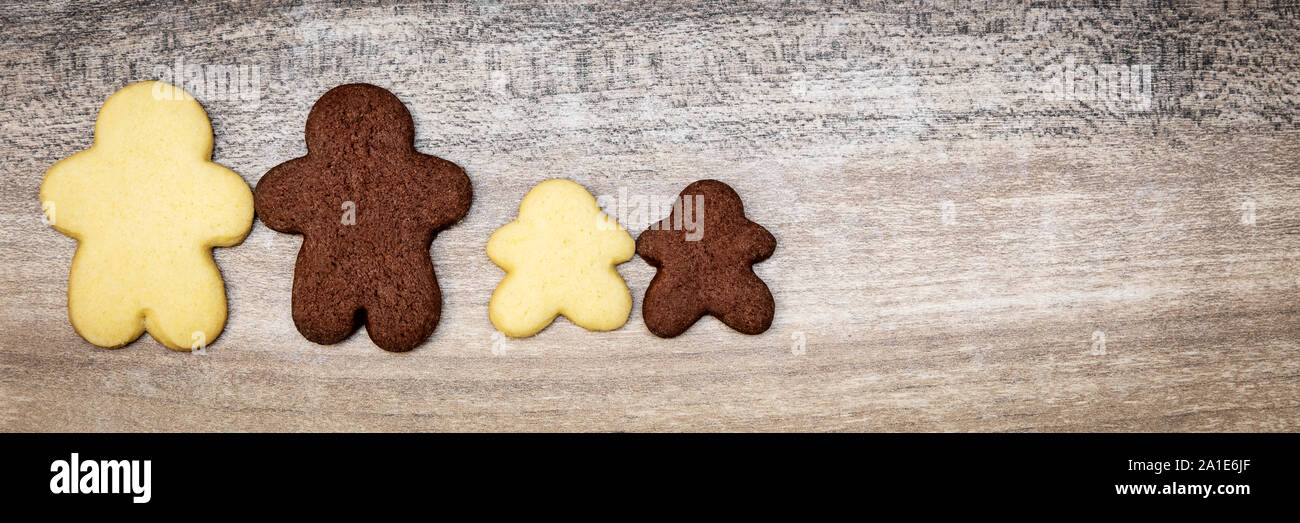 black and white human shape cookies, concept intercultural or multiracial family or friendship, copyspace Stock Photo
