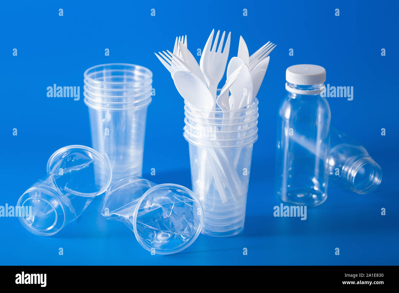 single use plastic bottles, cups, forks, spoons. concept of recycling