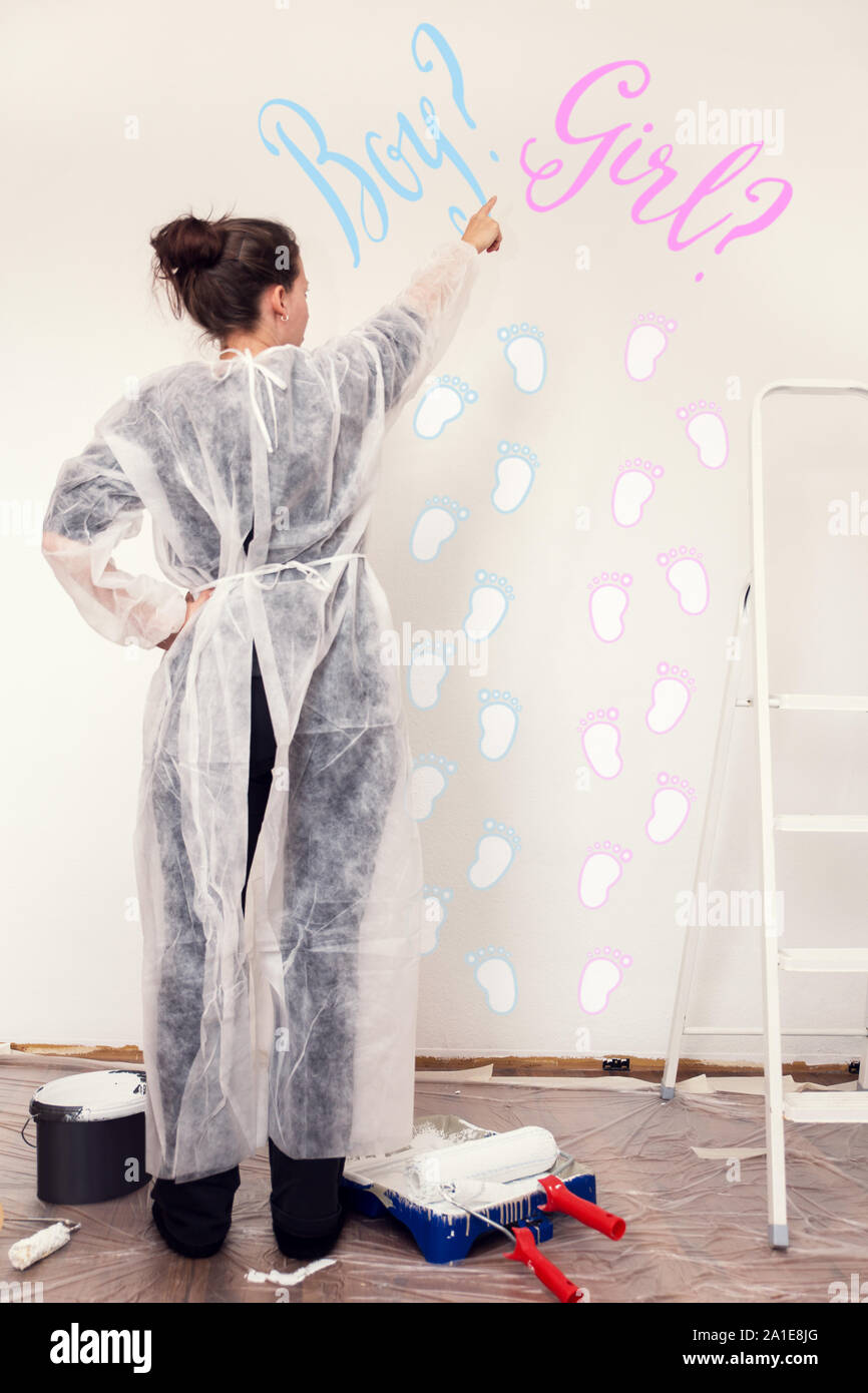 woman is painting a nursery, pink or blue, option for a boy or a girl, words and footprints Stock Photo