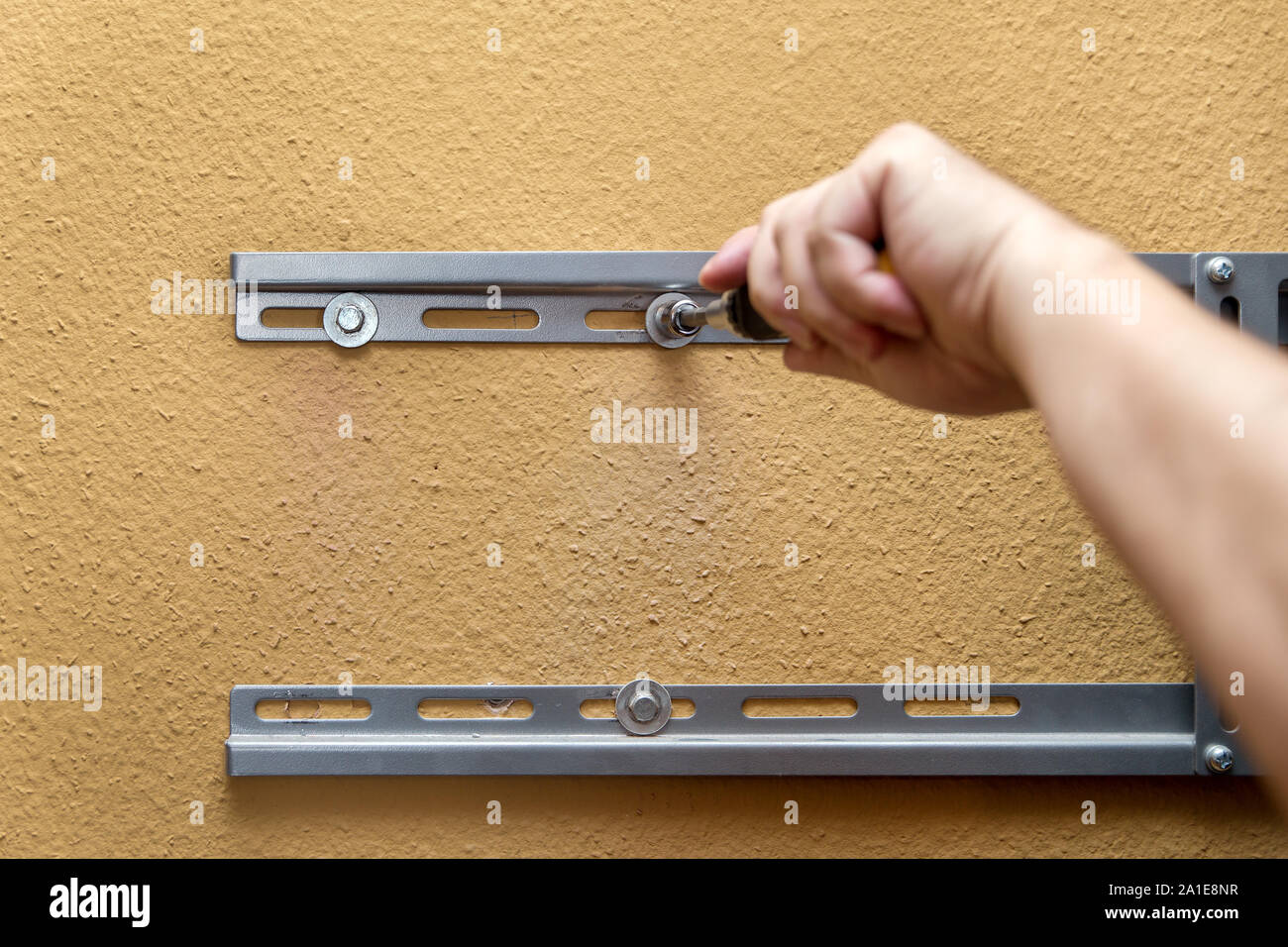 Service and installing, fitting bracket for a tv on the wall, closeup Stock Photo