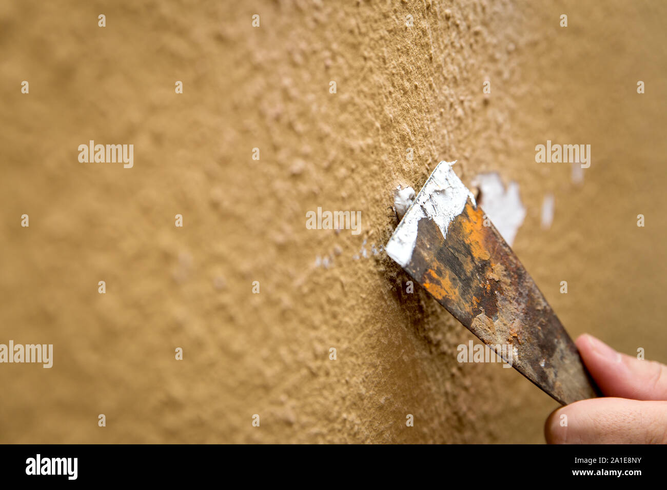 Renovation, repair and filling a hole with filler and a spatula Stock Photo