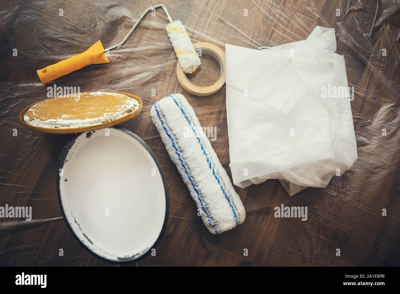 Flat lay, wall paint, roller and protective gown for Painting and renovation Stock Photo