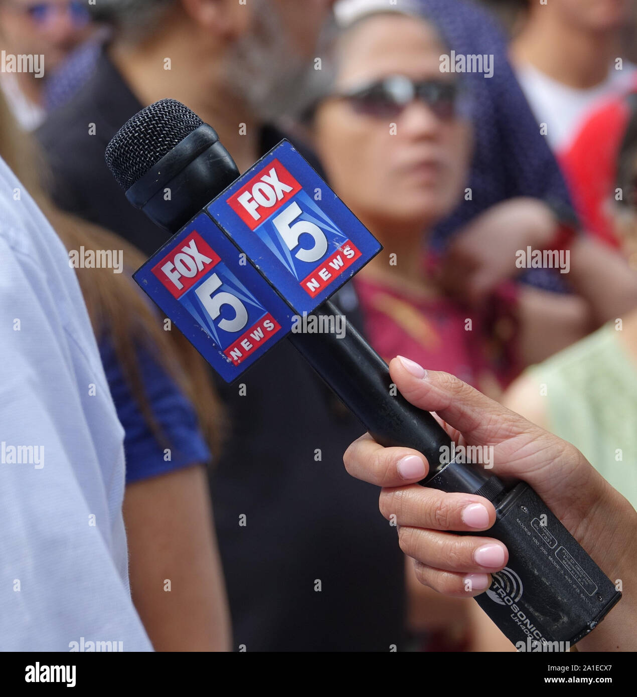 New York, USA. 11th Sep, 2019. One hand holds a microphone with the logo of the TV channel Fox 5 News. Fox 5 News is part of WNYW Channel 5, an American television channel based in New York. WNYW belongs to the FOX network. Credit: Alexandra Schuler/dpa/Alamy Live News Stock Photo