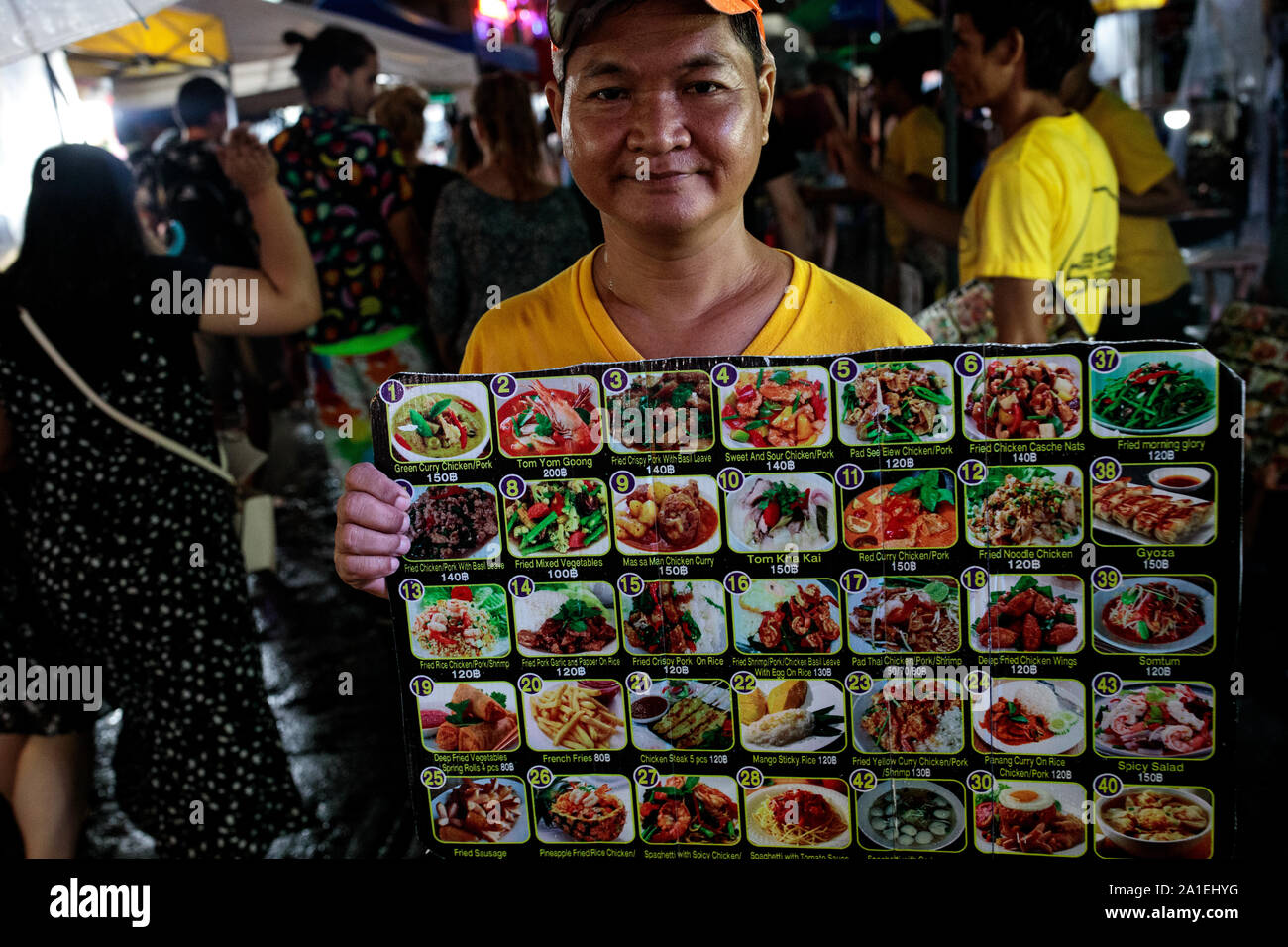 BANGKOK, THAILAND: A vendor displays a picture menu of Thai food outside a  restaurant on Khao San Road in Bangkok, Thailand on August 22nd, 2019.  Bangkoks bustling Khao San Road - a
