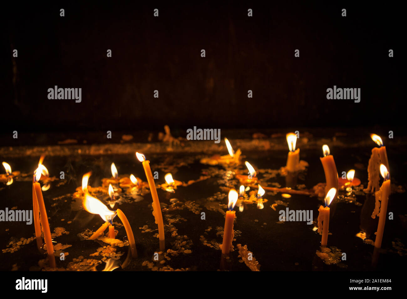 burning candles on black background Stock Photo - Alamy