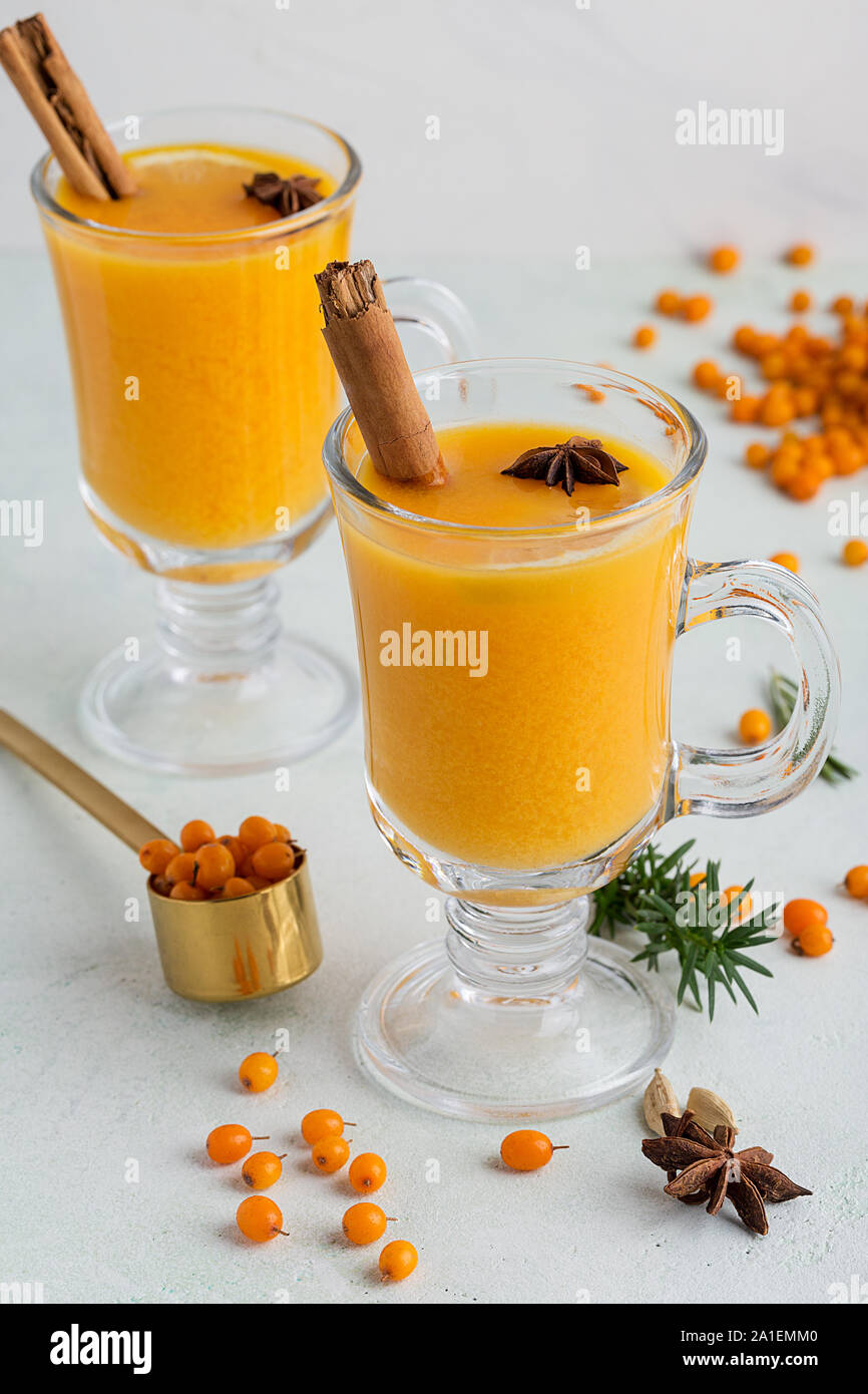 Sea buckthorn tea for two at white background with some ingredients around. Concept of healthy drinks. Image for text or recipe Stock Photo