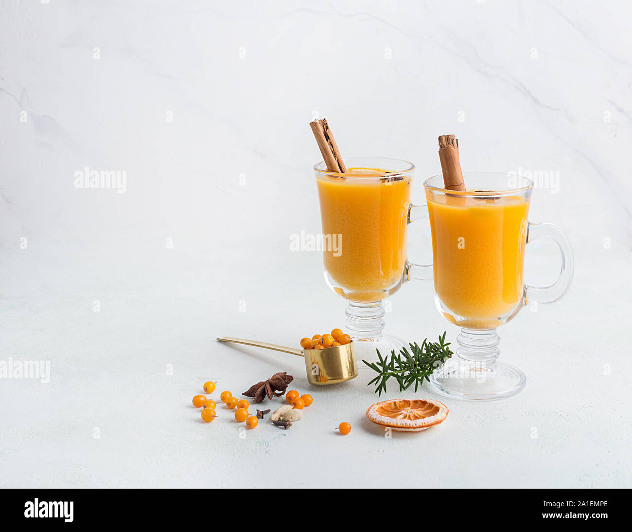 Copy space with sea buckthorn drinks in two glasses on white background for text or logo. Concept of seasonal beverage with copy space Stock Photo
