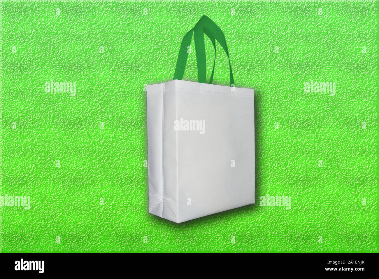 Box Type Bag, White Bag on Green Background Stock Photo