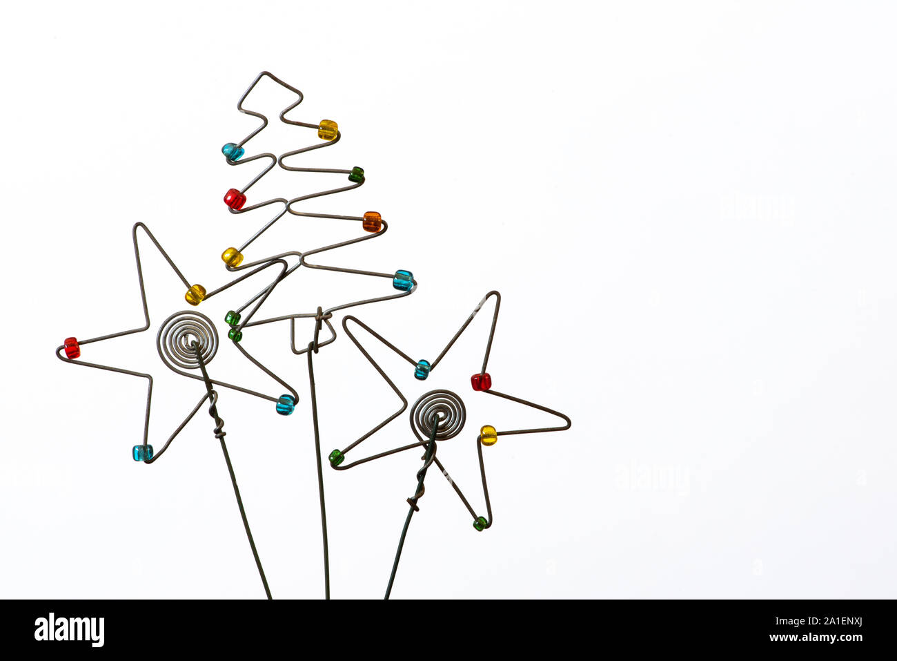An iconic but simple Christmas tree and two stars created out of wire and beads. Stock Photo