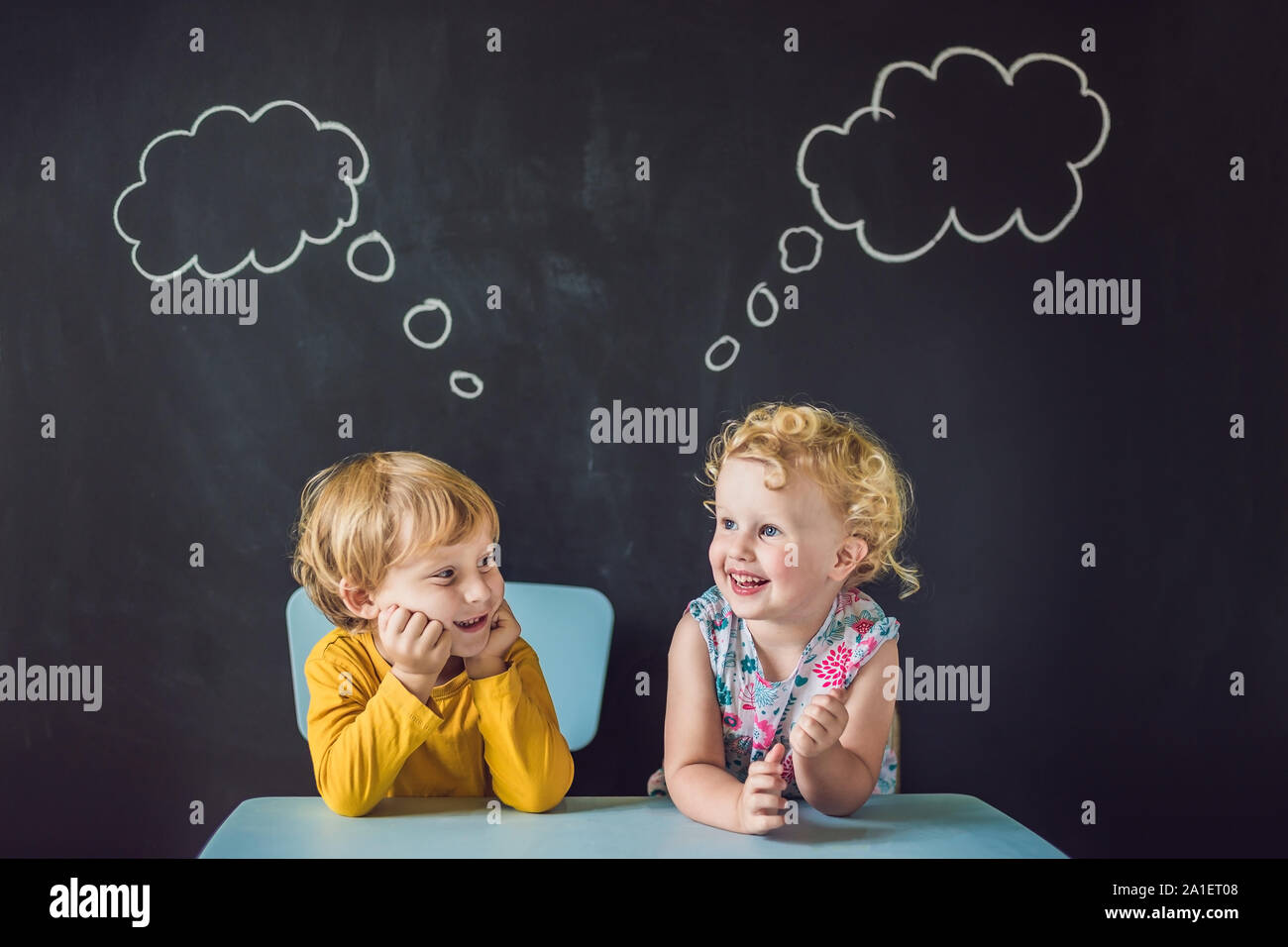The boy and the girl are thinking, choosing. Stock Photo